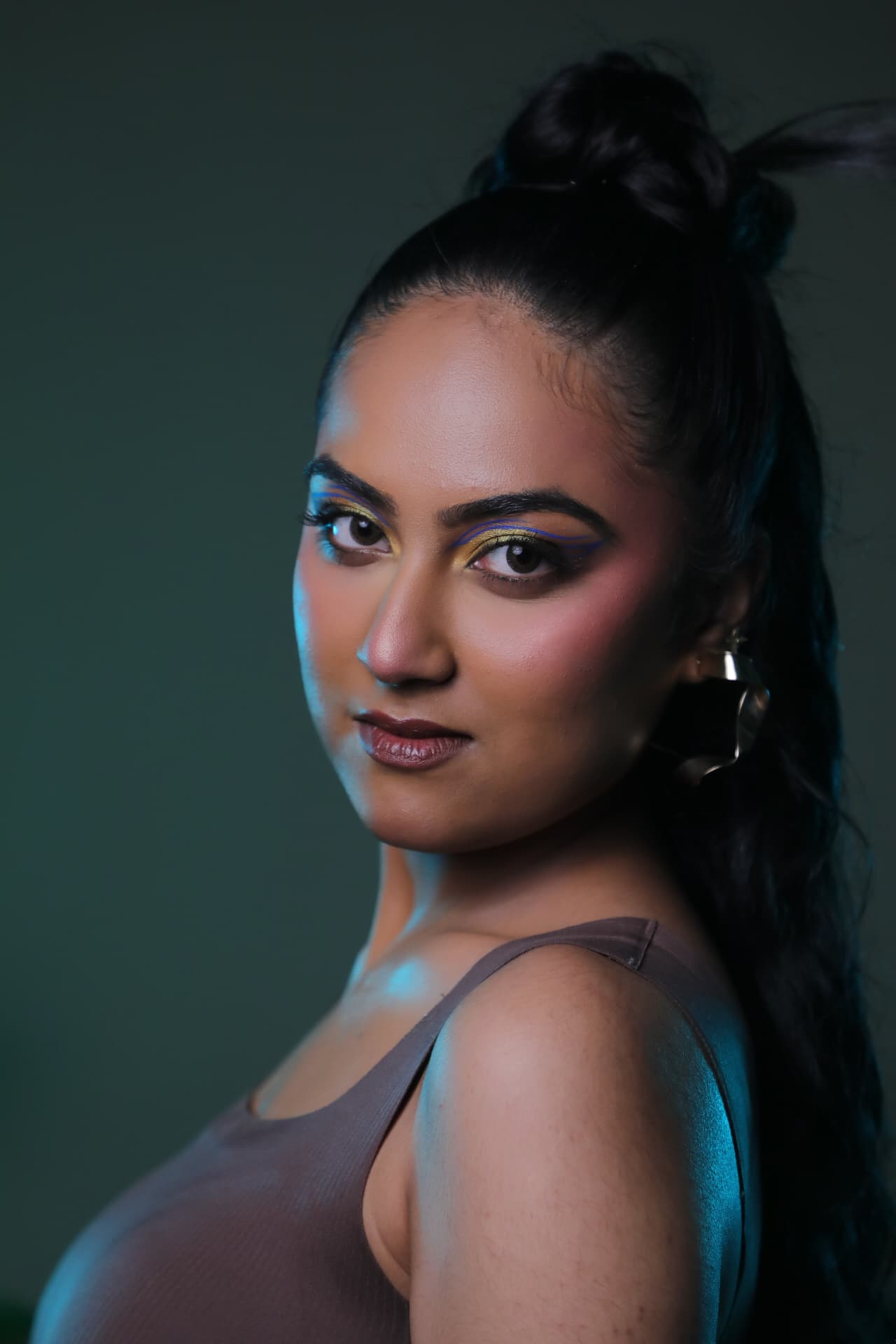 Creative colour eye makeup with gold and blue liner