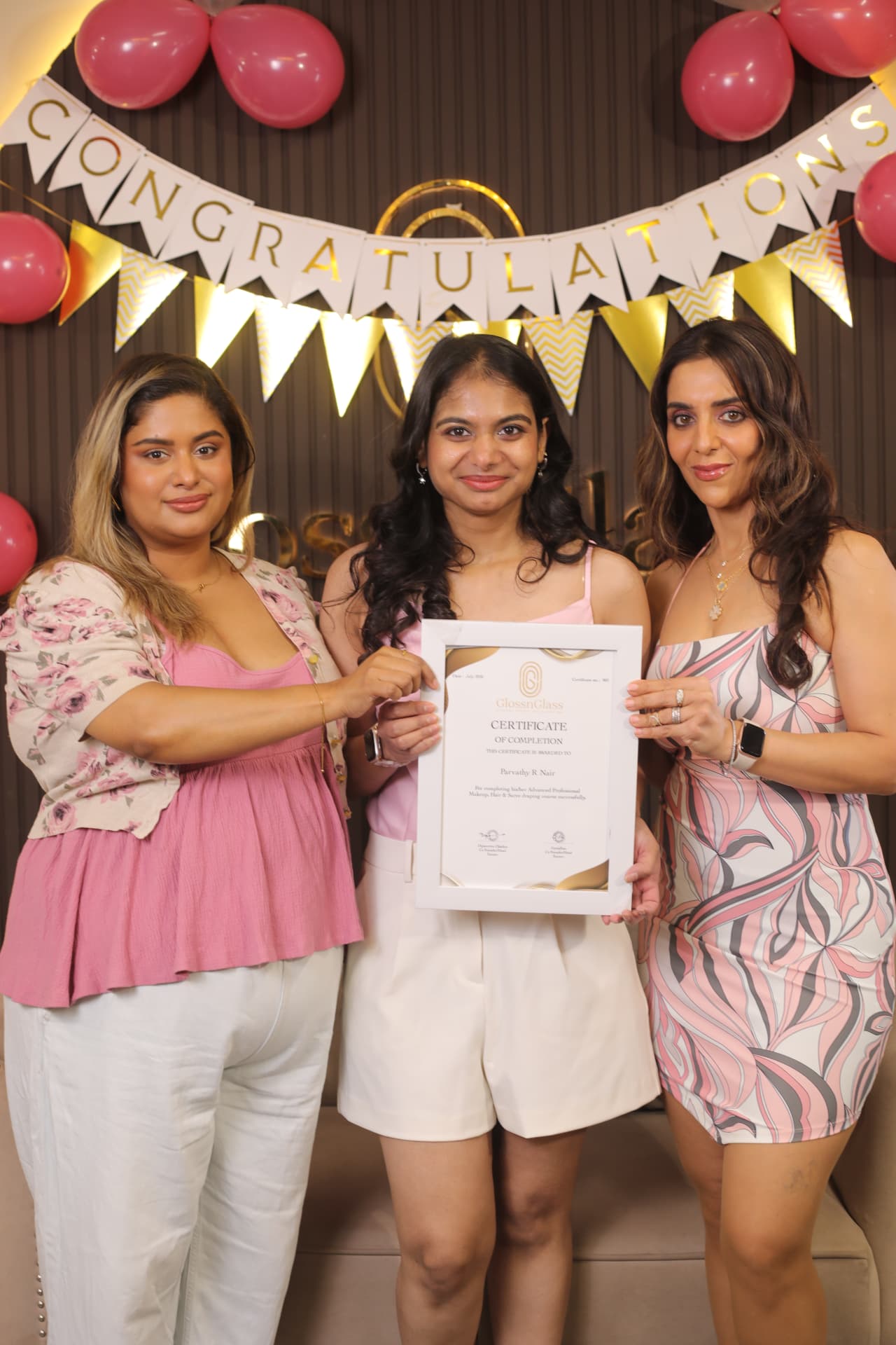 Student with the GlossnGlass founders on certification day
