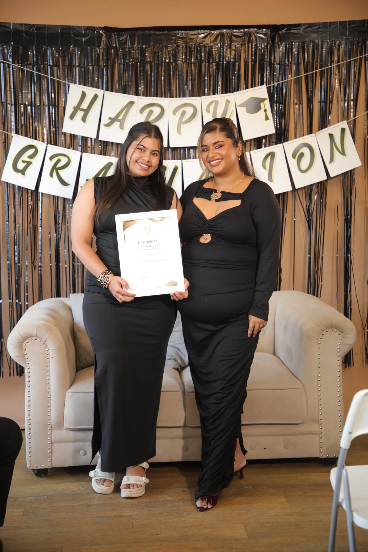 Two GlossnGlass graduates holding a certificate