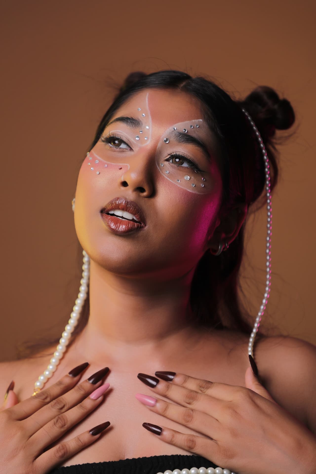 Avant garde makeup with crystals and pearl styling